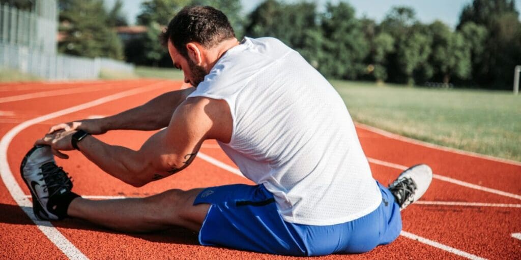 Man Stretching on Track Before Exercise Workout