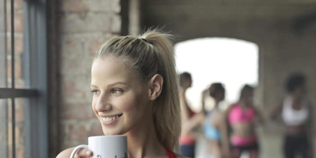 Woman Having Mug of Coffee Before Exercise Workout
